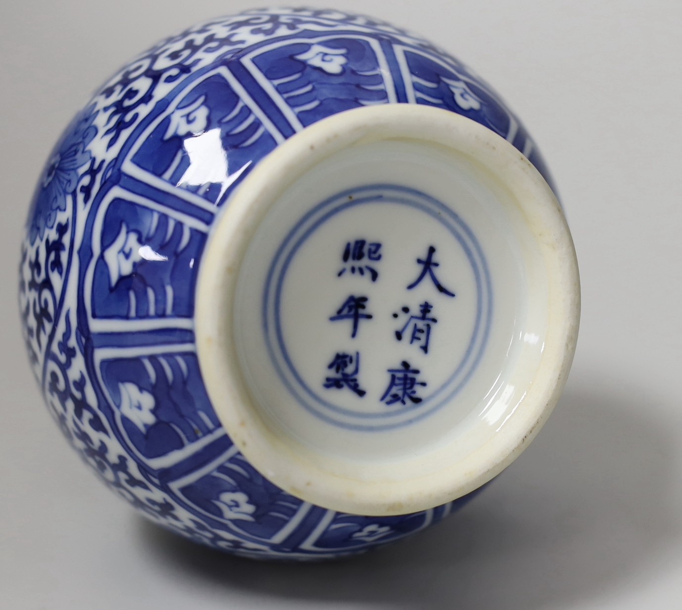 A late 19th century Chinese blue and white ‘eight Buddhist emblems’ vase, apocryphal Kangxi mark, 23cm